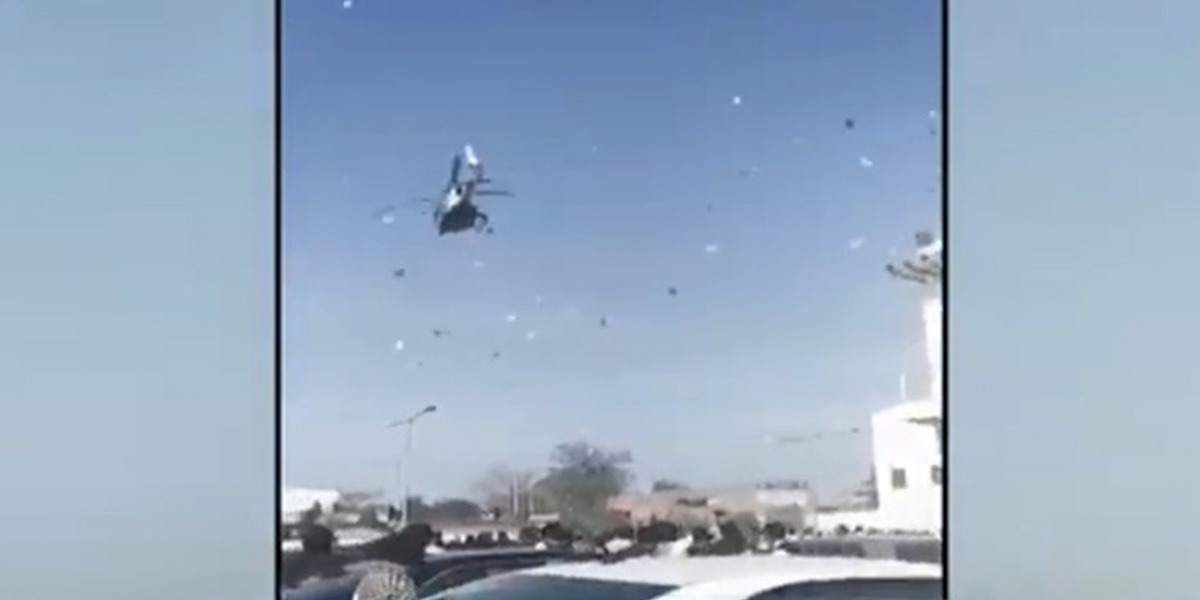 Money showered from helicopter at a wedding