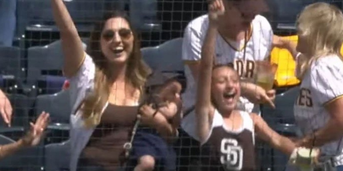 Woman Holding A Baby In Her Hand Catches The Ball With Another Hand