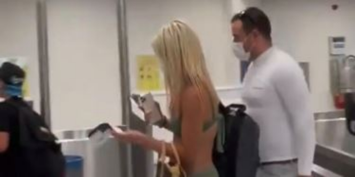 Woman passenger walks through airport in just bikini and face mask---Video goes viral