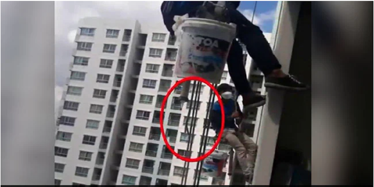 Woman cuts the support rope of two workers left dangling from 26th floor