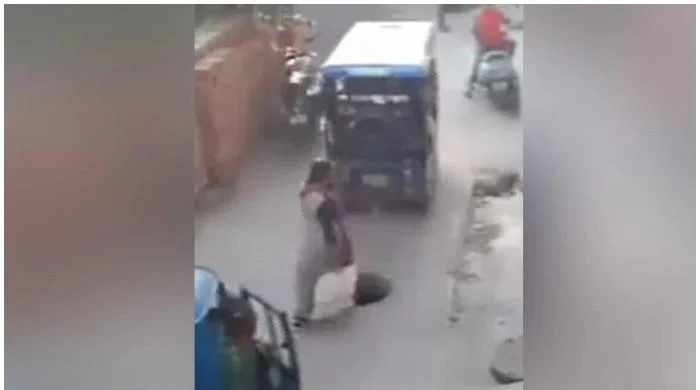 Viral video: A woman falls into a manhole while talking on her phone