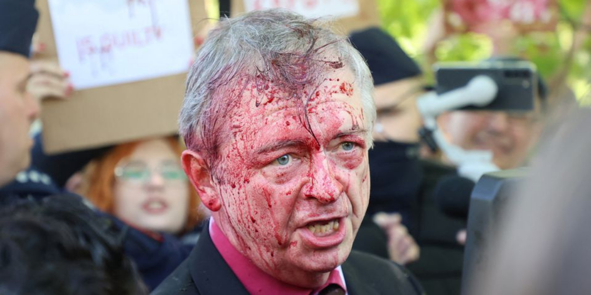 Anti-war protesters spray red crimson paint on Russian envoy to Poland