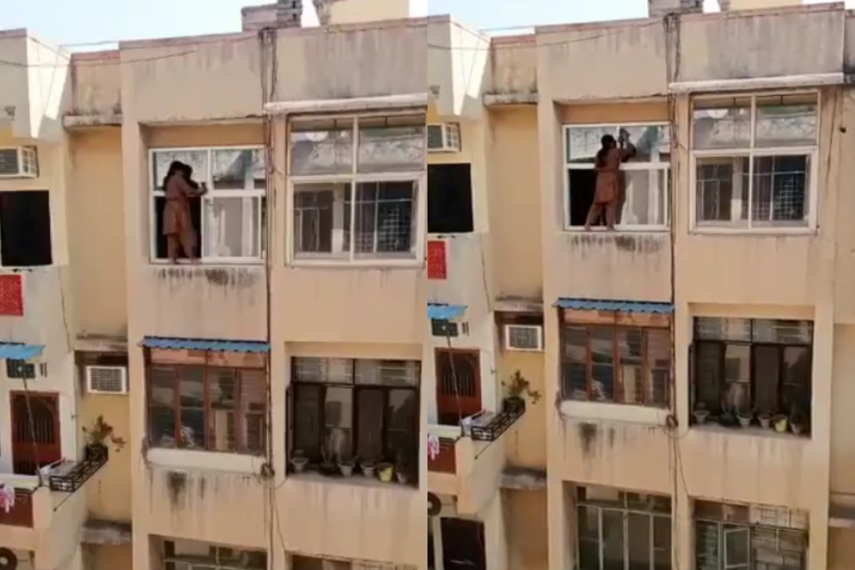 Woman stands on railing