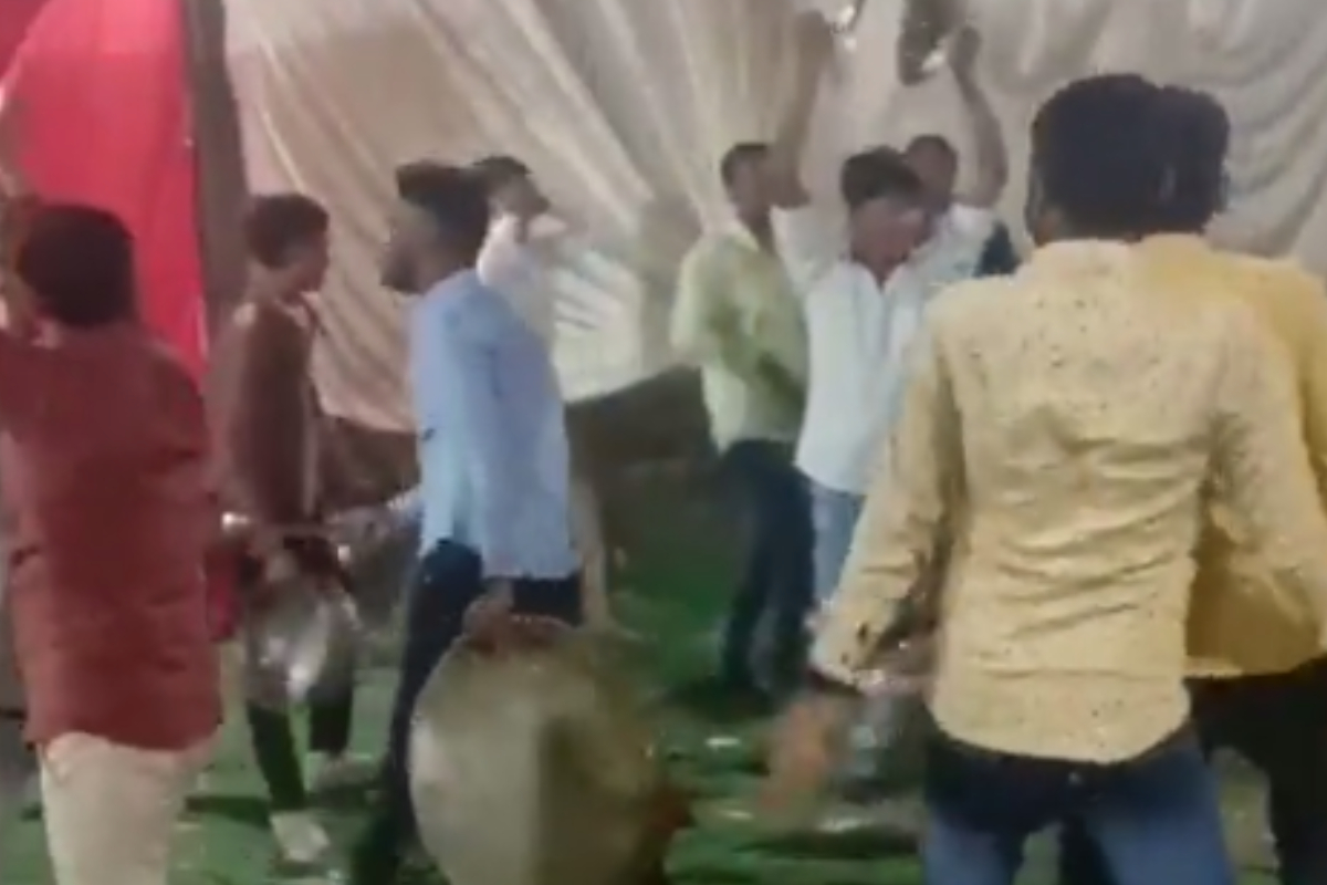 Men dancing with wedding utensils