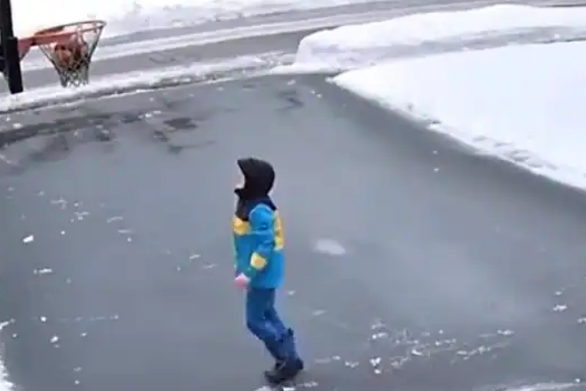 Boy playing basketball in cold