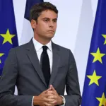 French PM looks to rebuild political support after party backing