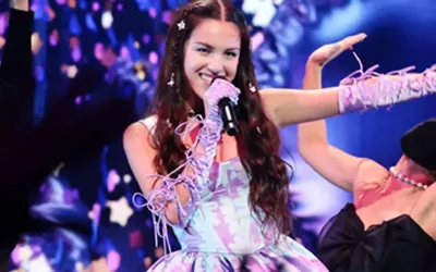 Pop star expands empire with festival, chart success, and upcoming world tour