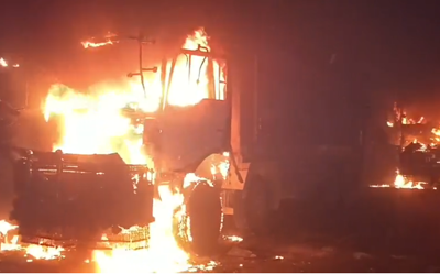 Two siblings killed in Karachi, mob torches seven dumpers