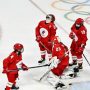 Olympic hockey players wear Covid face masks during match