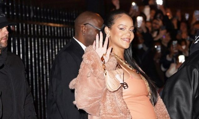 Rihanna looks stunning in a leather mini dress at the fashion show in Paris