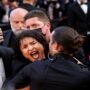 A protester dressed in Ukraine colours was ejected from the Cannes Red Carpet
