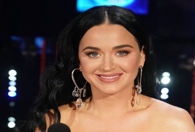 Stunning in an orange maxi skirt and a purple bodysuit, Katy Perry is pictured