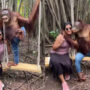 Chimpanzee in jeans kisses photographer