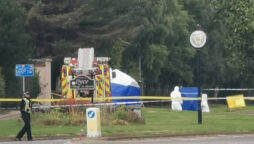 Woman found dead at roundabout, man arrested