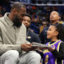 LeBron James signs his children’s book ‘I Promise’ for girl
