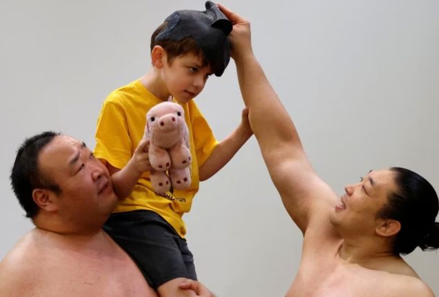 Sumo wrestlers give up the dohyo for the stage to entertain foreign tourists